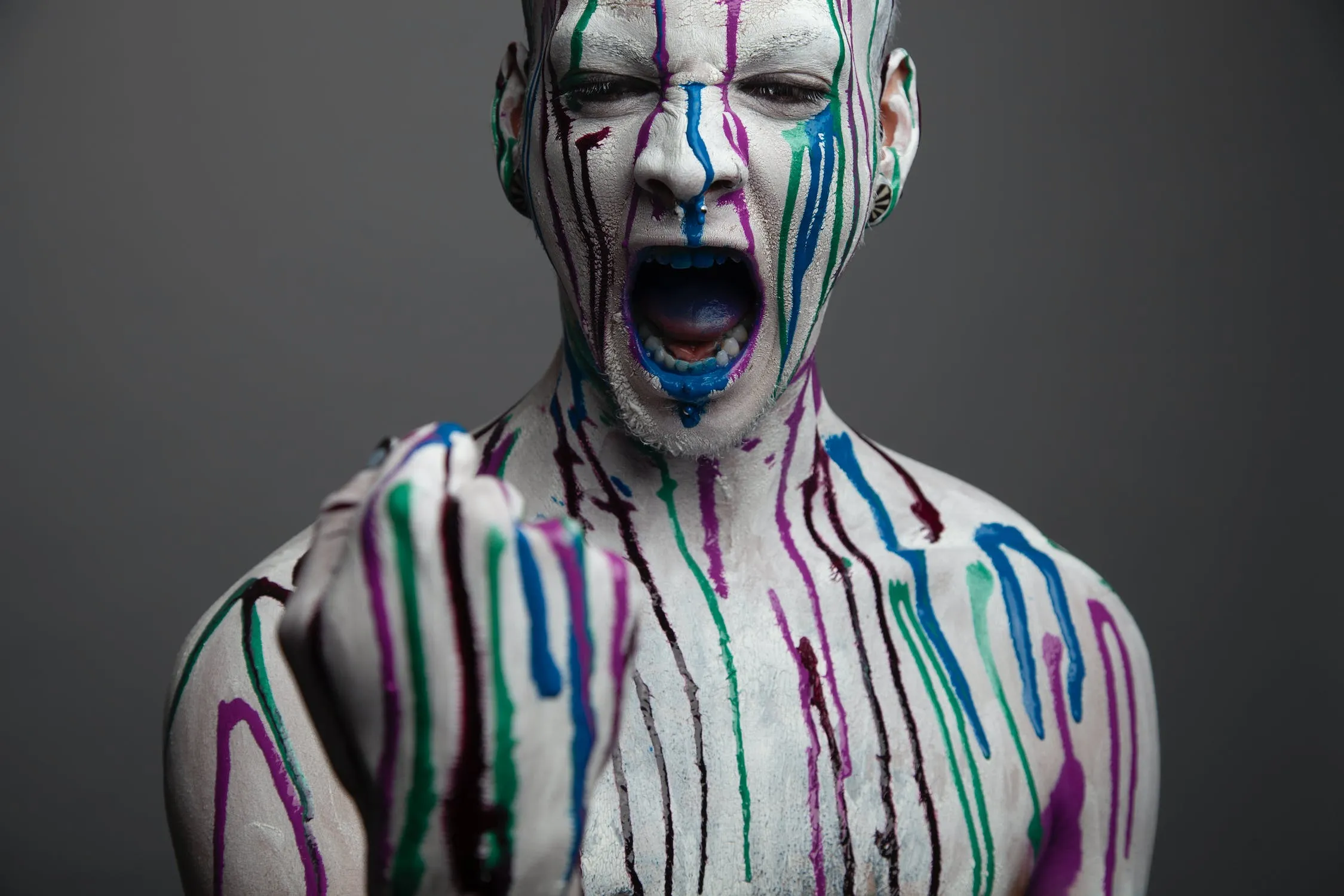 free-photo-of-screaming-man-with-colorful-paint-on-body-and-face.jpeg